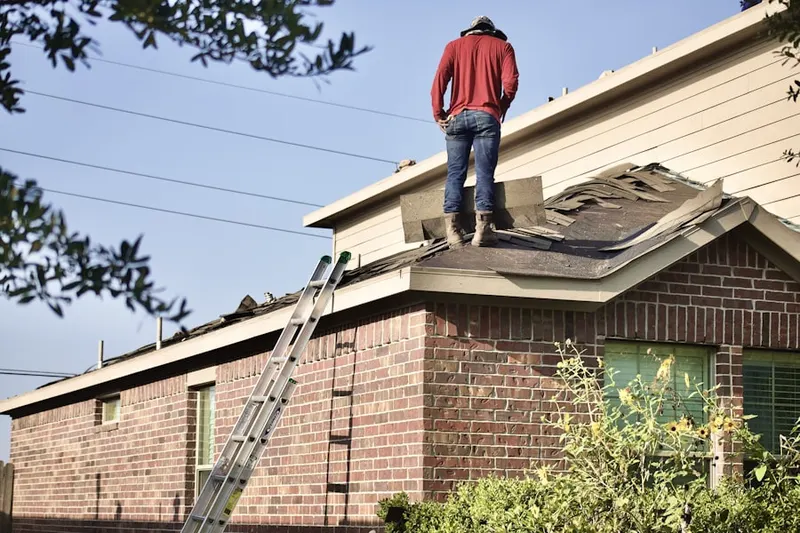 Professional roofer working on a residential roof in Hanson